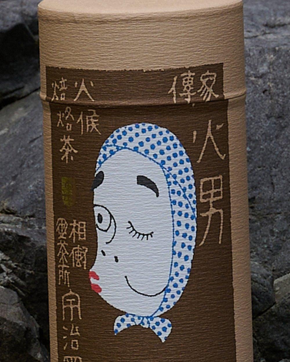 火男の缶に描かれたひょっとこ